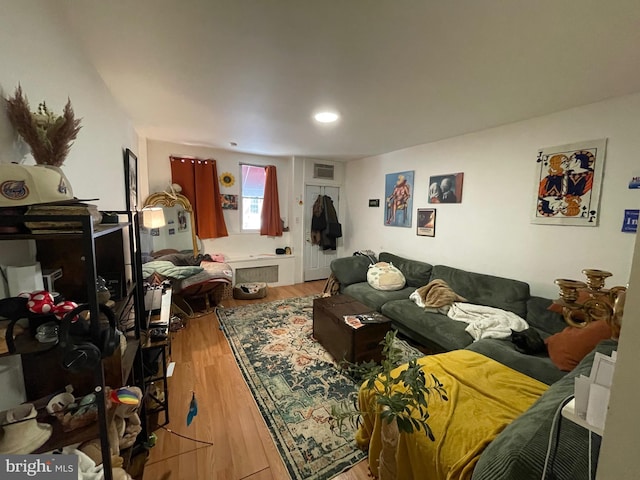 living room with visible vents and wood finished floors