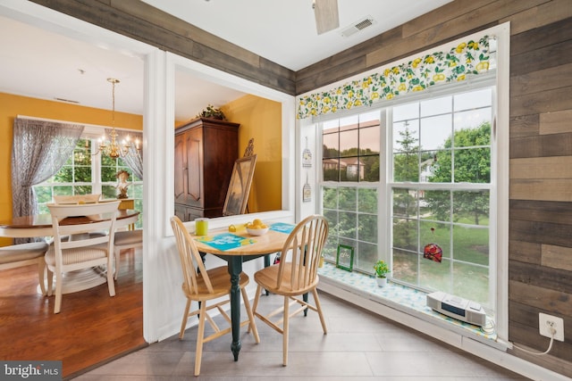 sunroom / solarium featuring a chandelier