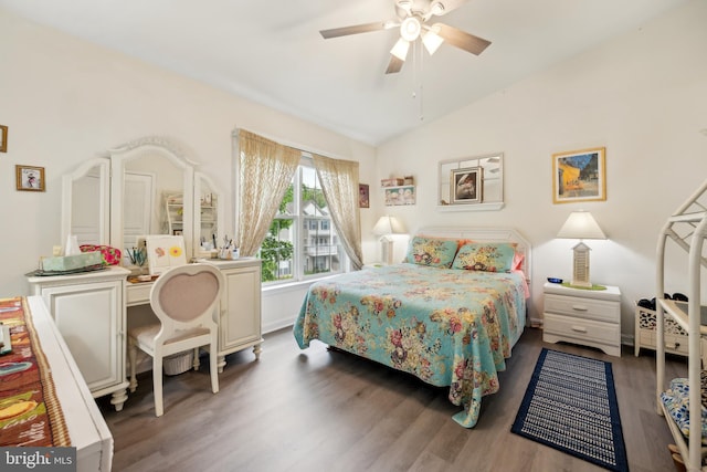 bedroom featuring wood finished floors, lofted ceiling, ceiling fan, and baseboards