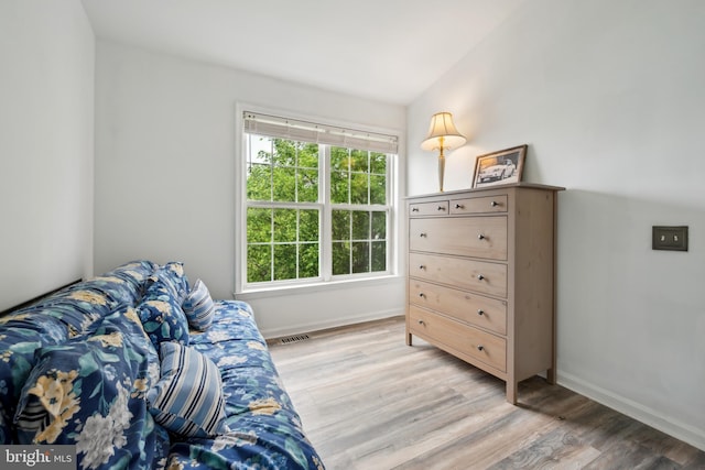 bedroom with baseboards and light wood finished floors