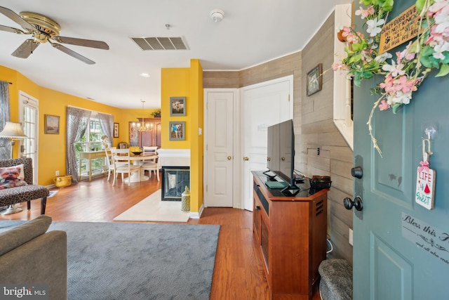 living room featuring wood finished floors, ceiling fan, a chandelier, and recessed lighting