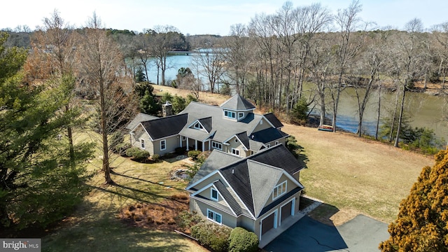 drone / aerial view with a water view and a forest view