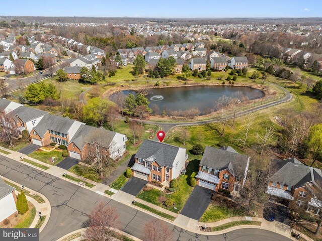 bird's eye view with a residential view and a water view