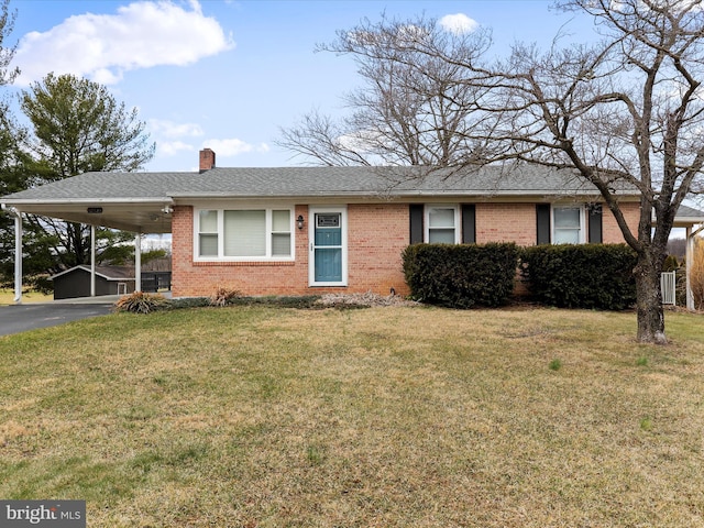 ranch-style home with driveway, an attached carport, a front yard, and brick siding