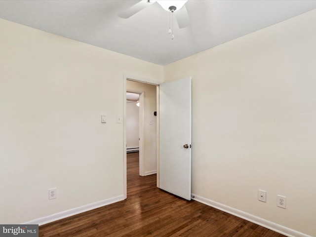 empty room featuring a ceiling fan, baseboards, and wood finished floors