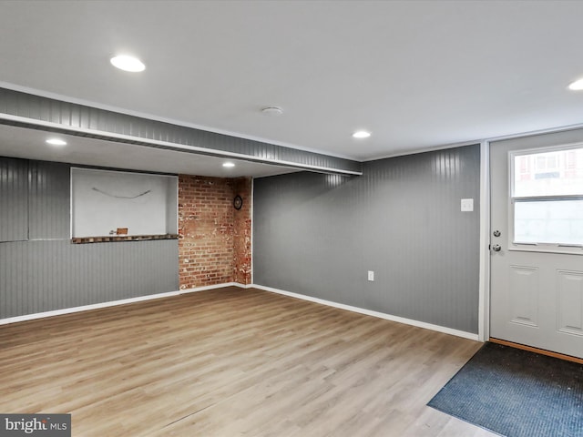 below grade area featuring baseboards, wood finished floors, and recessed lighting