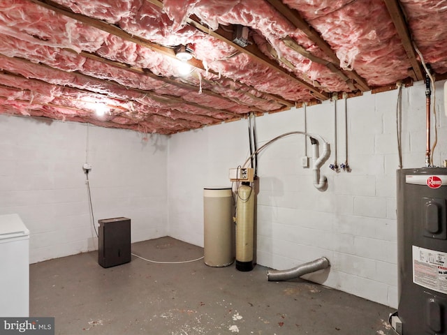 unfinished basement featuring electric water heater