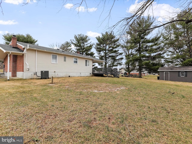 view of yard featuring central AC and a deck