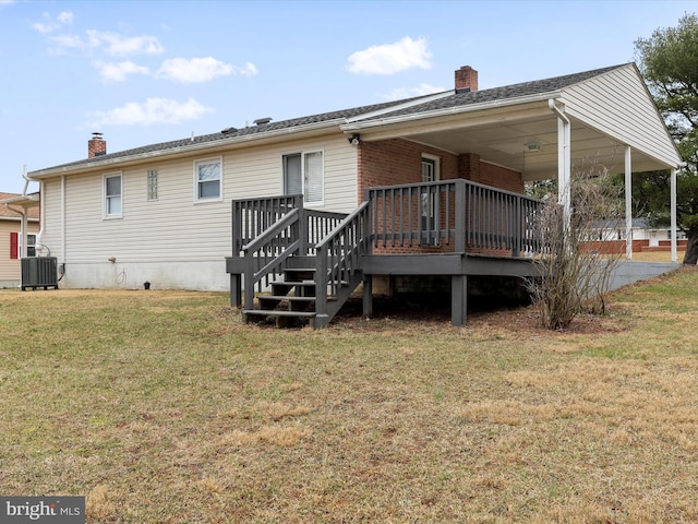 back of house with a deck, a yard, a chimney, and cooling unit