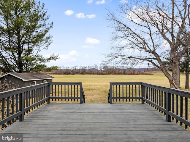 wooden deck with a lawn and an outdoor structure