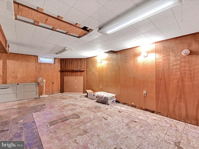 basement with wood walls and tile patterned floors