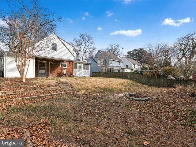 view of yard with a sunroom and fence