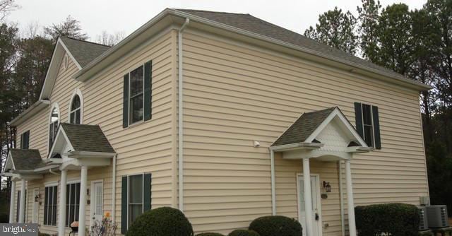 view of side of home featuring cooling unit