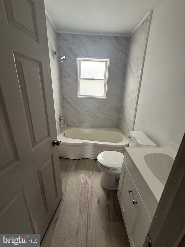 bathroom featuring bathing tub / shower combination, vanity, toilet, and wood finished floors