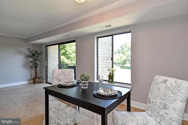 dining space with light tile patterned flooring, visible vents, baseboards, and ornamental molding