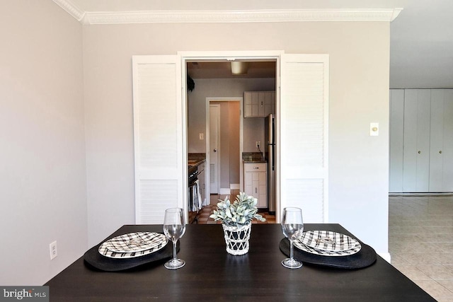 tiled dining room with ornamental molding