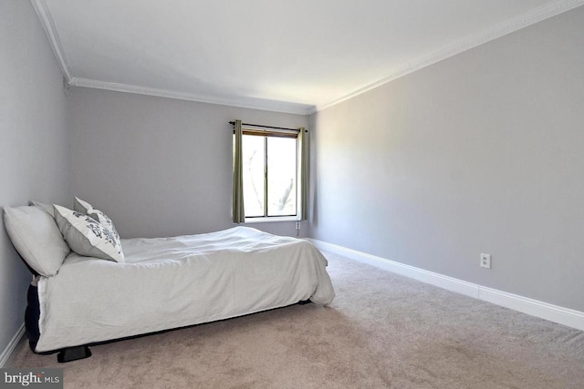 carpeted bedroom with crown molding and baseboards