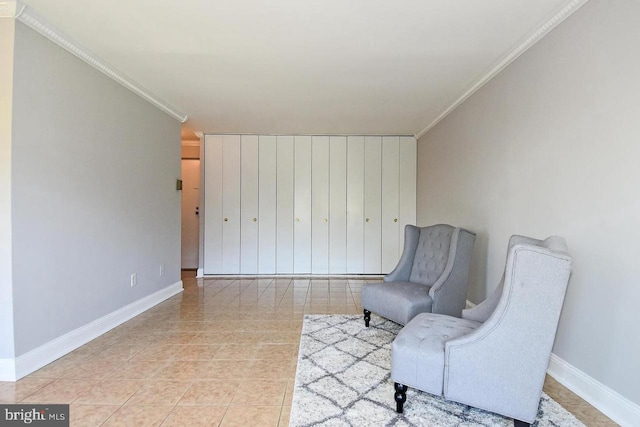 living area with tile patterned floors, baseboards, and crown molding