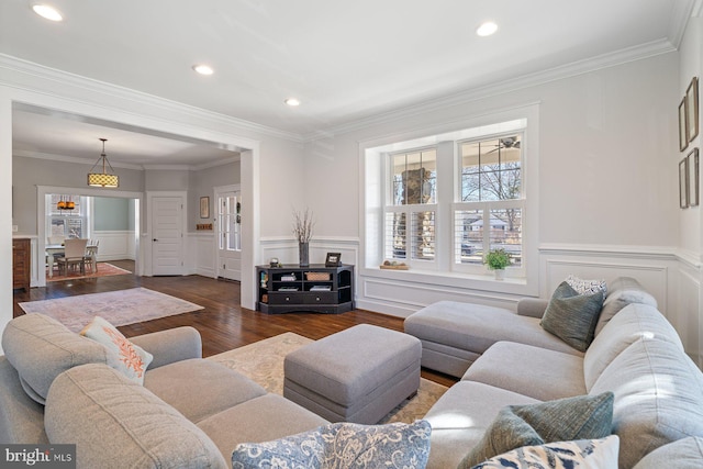 living area featuring dark wood-type flooring, recessed lighting, a wainscoted wall, and ornamental molding