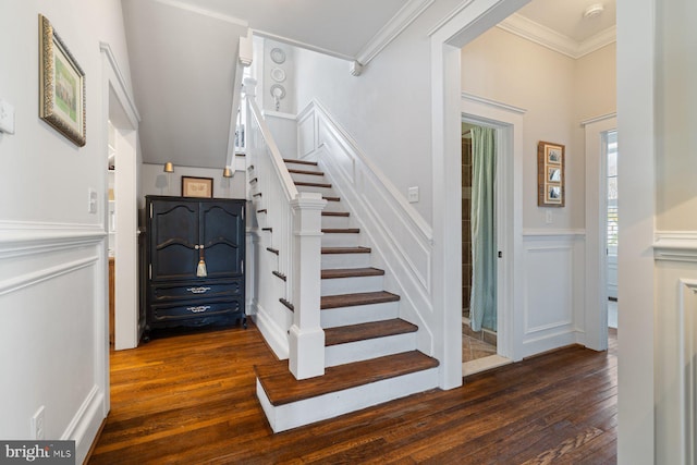 staircase with hardwood / wood-style flooring, a decorative wall, crown molding, and a wainscoted wall