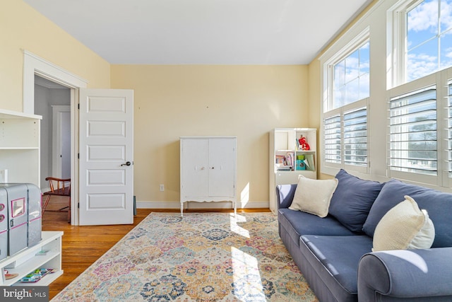 living area featuring baseboards and wood finished floors