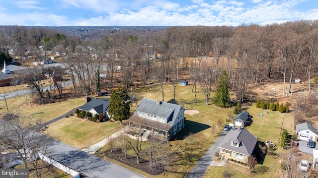 birds eye view of property featuring a view of trees