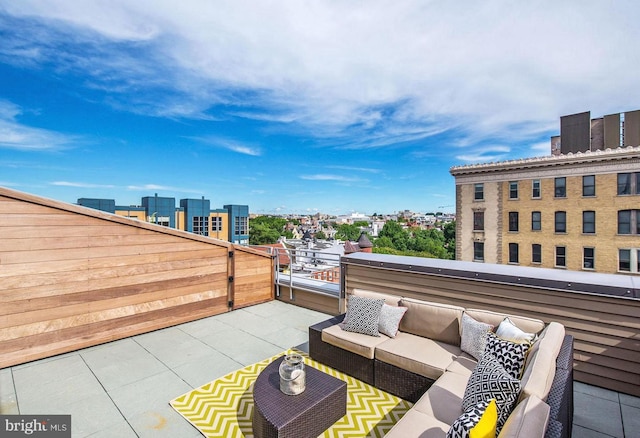 view of patio with a city view, a balcony, and an outdoor hangout area