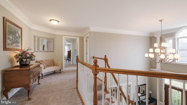 hall featuring crown molding, light colored carpet, a notable chandelier, and an upstairs landing