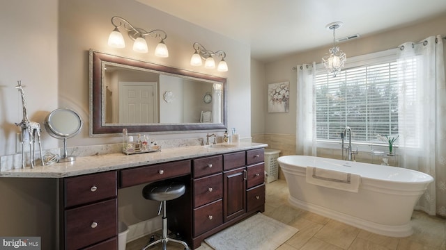 bathroom with a soaking tub, vanity, visible vents, and tile walls