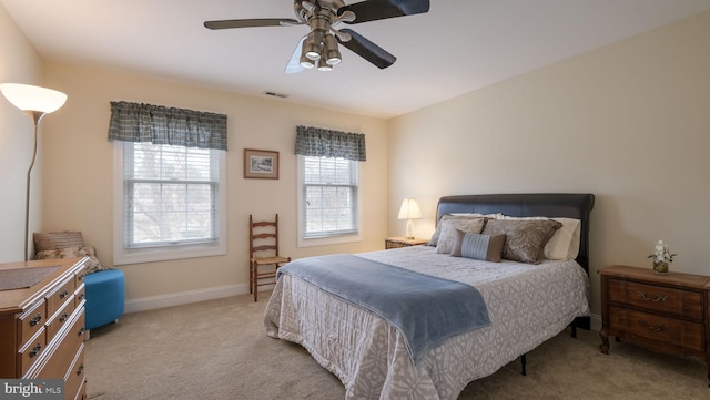 bedroom featuring carpet floors, baseboards, visible vents, and a ceiling fan