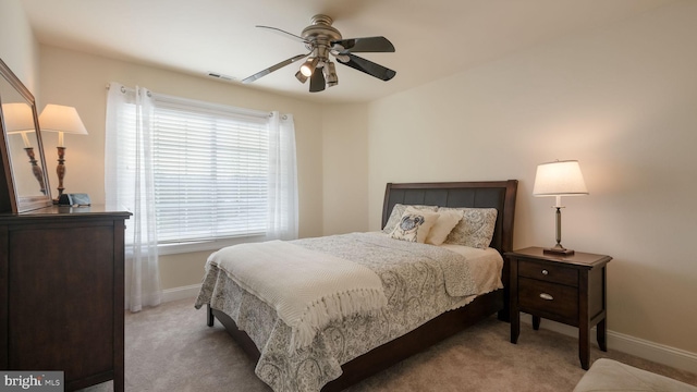 carpeted bedroom with a ceiling fan, visible vents, and baseboards