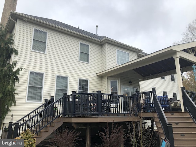 rear view of house with a deck and stairway