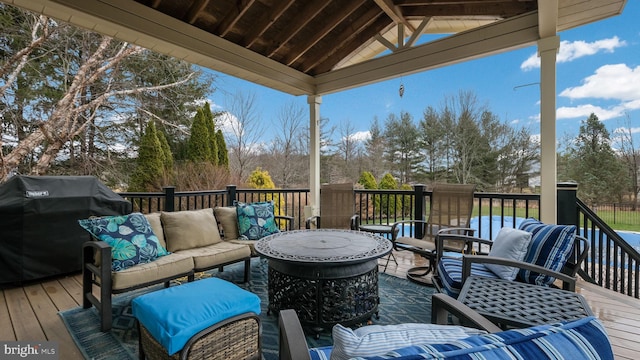 wooden deck featuring an outdoor living space and grilling area