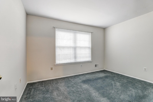 empty room with visible vents, baseboards, and carpet