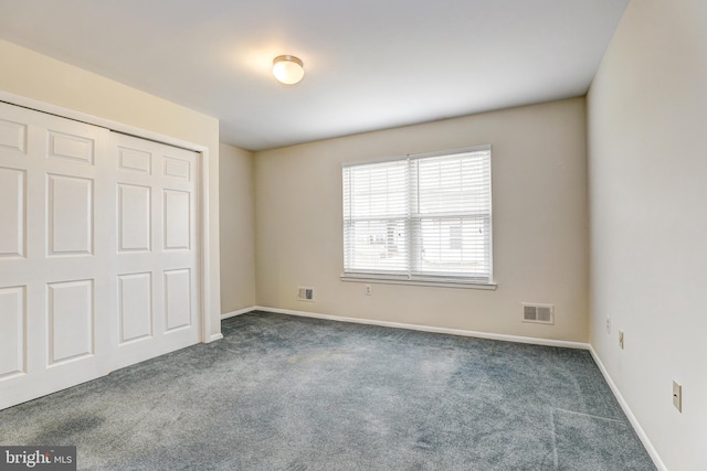 unfurnished bedroom featuring a closet, visible vents, baseboards, and carpet floors