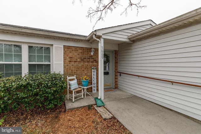 entrance to property with brick siding