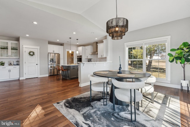 dining area featuring lofted ceiling, recessed lighting, dark wood-style floors, and baseboards