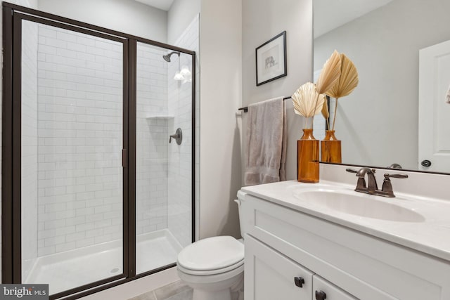 full bathroom with vanity, toilet, and a shower stall