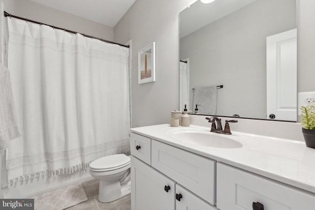 bathroom featuring vanity, tile patterned floors, and toilet