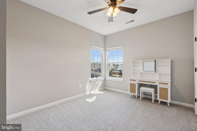 interior space with visible vents, baseboards, a ceiling fan, and carpet flooring