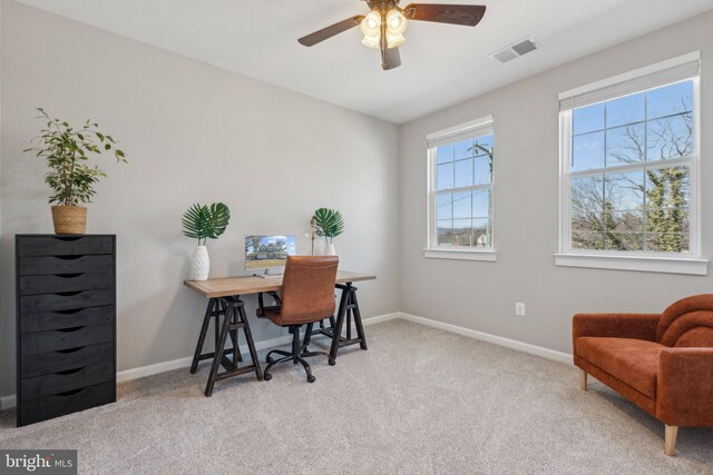 carpeted home office featuring visible vents, ceiling fan, and baseboards