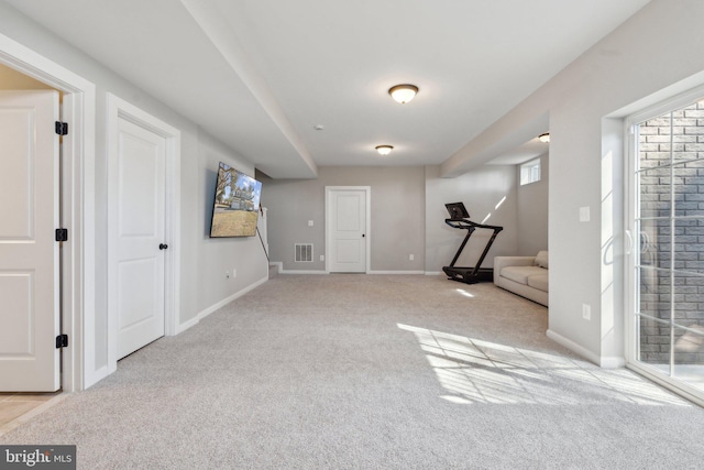 interior space featuring visible vents, baseboards, and carpet