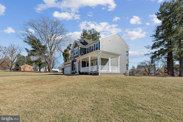 view of front of property with a garage, covered porch, and a front yard