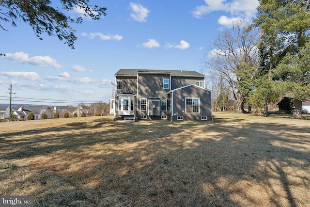 rear view of house with a lawn