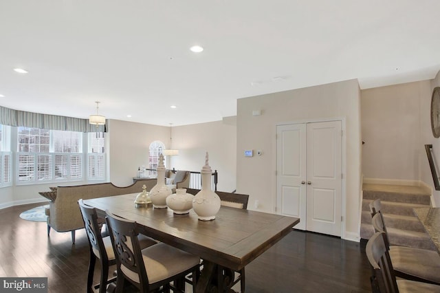 dining area with recessed lighting, dark wood finished floors, baseboards, and stairs