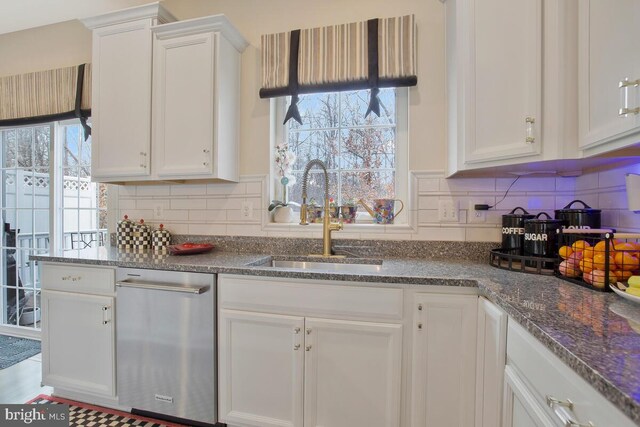 kitchen with white cabinetry, a sink, backsplash, and dishwasher