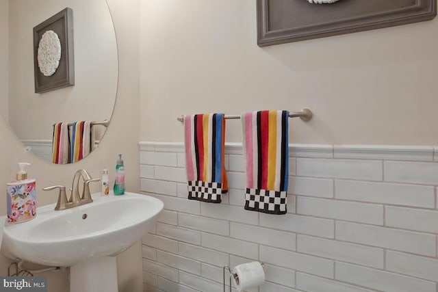 bathroom featuring a wainscoted wall and a sink