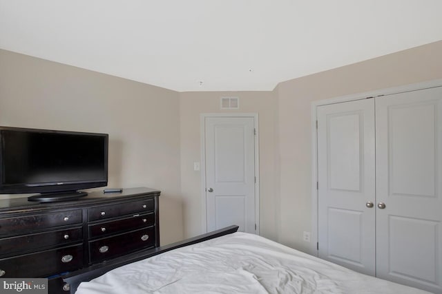 bedroom with a closet and visible vents