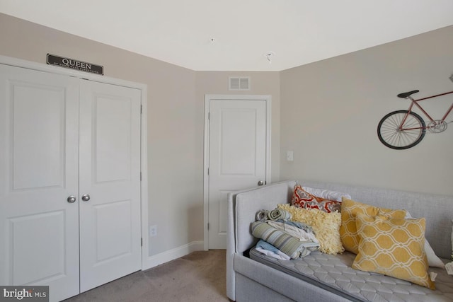 sitting room with carpet, visible vents, and baseboards