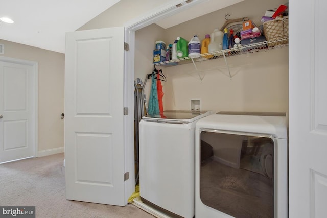 washroom featuring laundry area, light carpet, independent washer and dryer, and baseboards